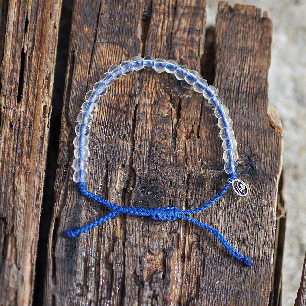 4ocean Signature Blue Bracelet on weathered driftwood